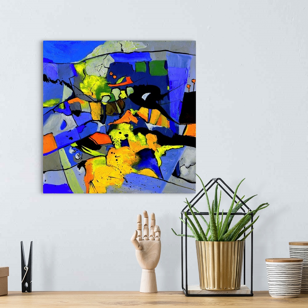 A bohemian room featuring A square abstract painting in vibrant shades of black, blue, orange and yellow with splatters of ...