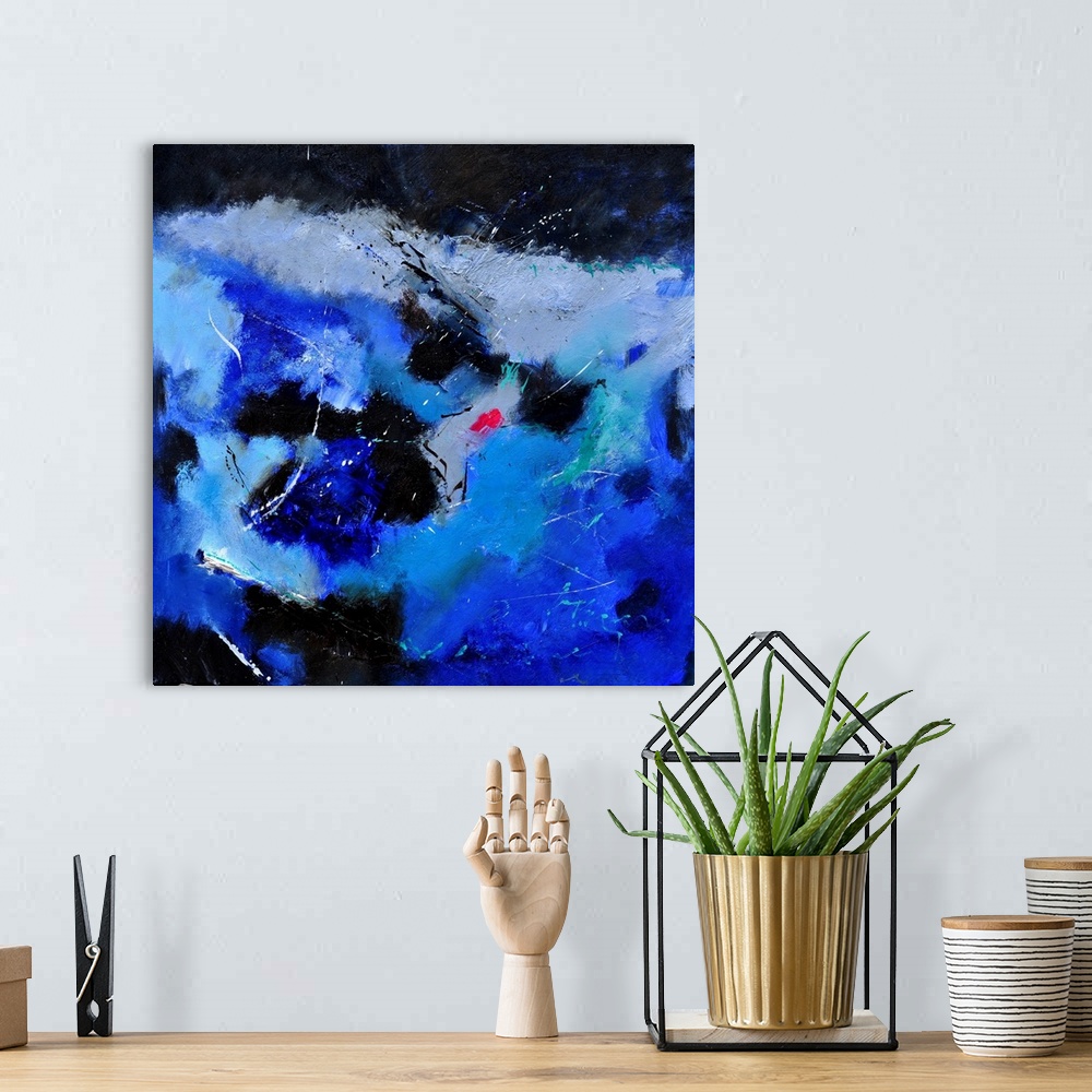 A bohemian room featuring A square abstract painting of colors of black, white and blue in bold brush strokes and splattere...
