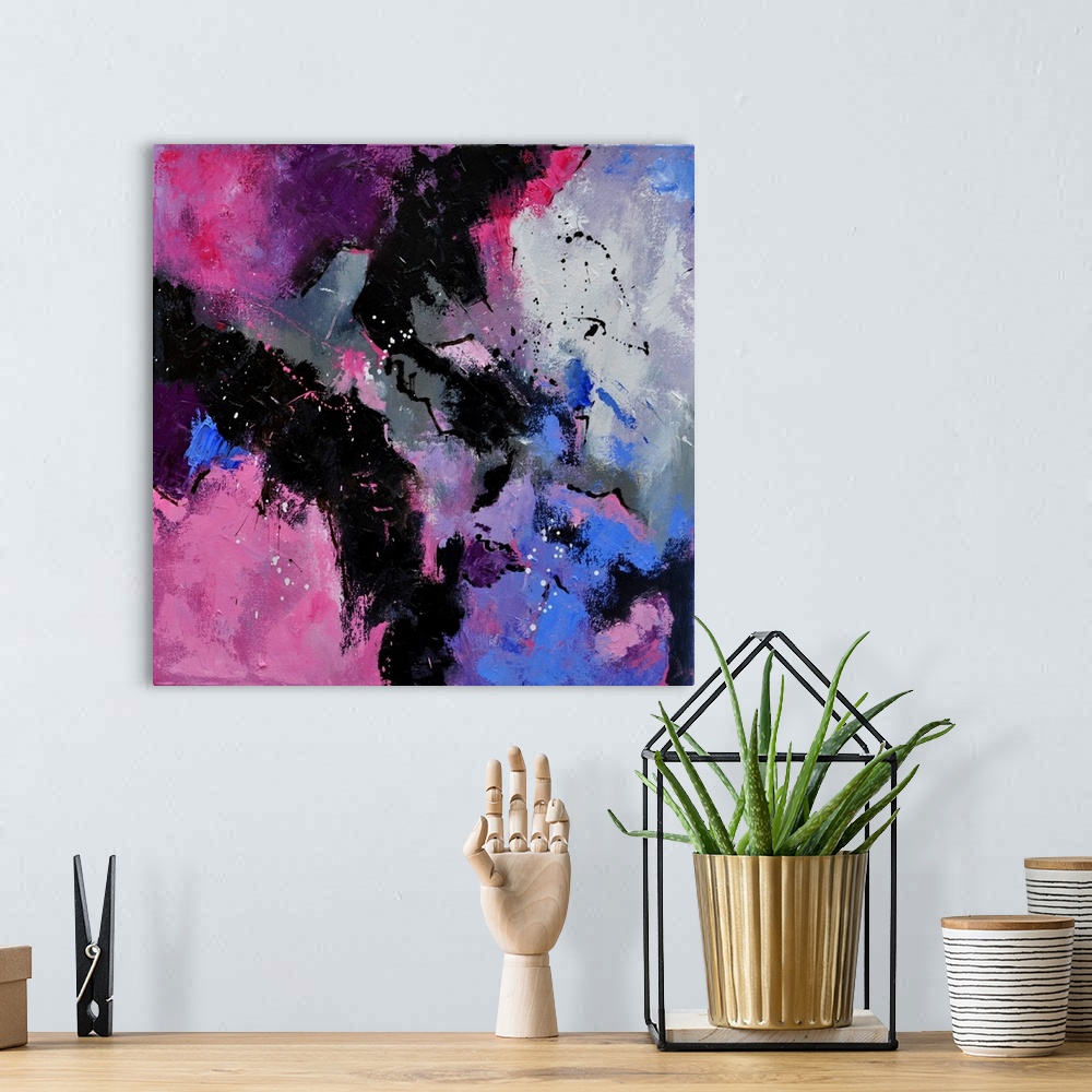 A bohemian room featuring A square abstract painting in dark shades of black, purple and pink with splatters of paint overl...