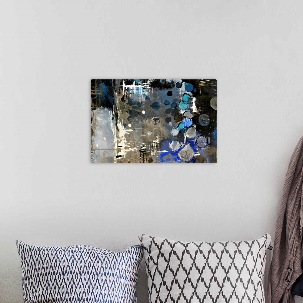 A bohemian room featuring Abstract painting of colors of blue, white and black in bold brush strokes and splattered paint.
