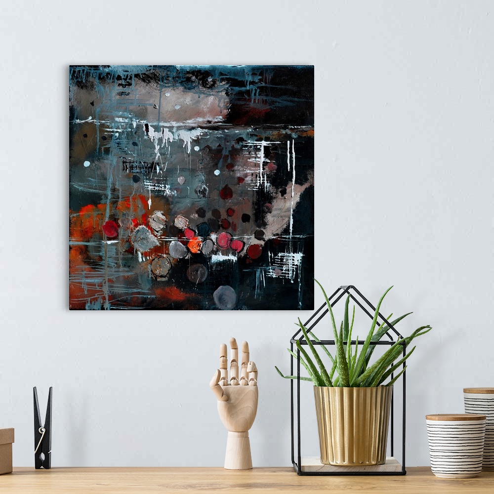 A bohemian room featuring A square abstract painting in dark shades of black, red and white with splatters of paint overlap...