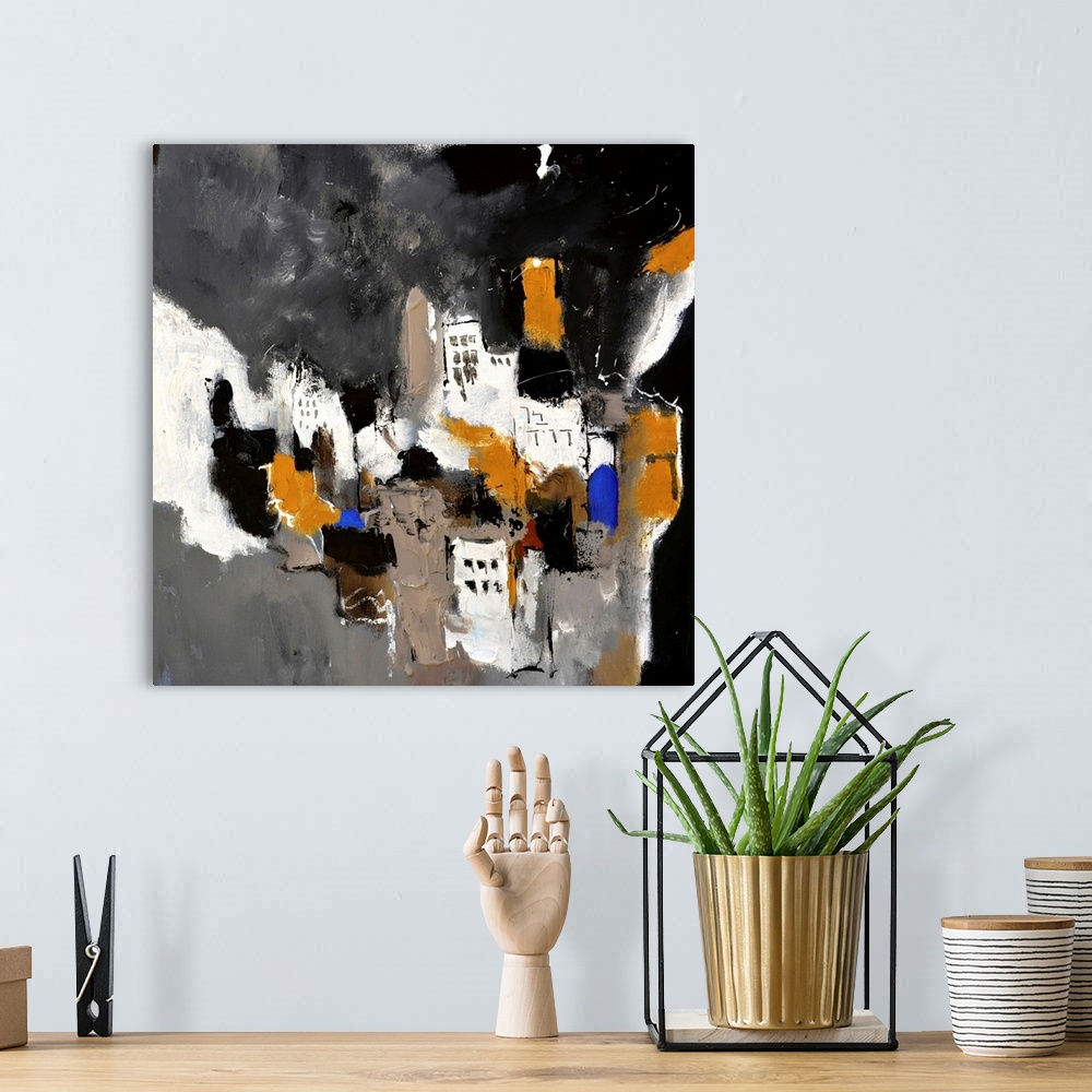 A bohemian room featuring A square abstract painting in textured shades of black, brown, white and blue with splatters of p...