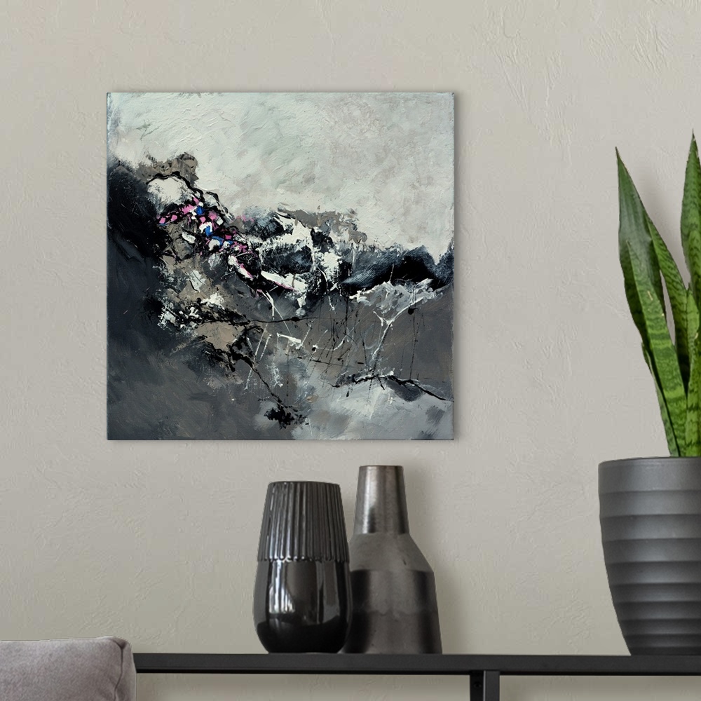 A modern room featuring A square abstract painting in shades of black and gray with splatters of paint overlapping.