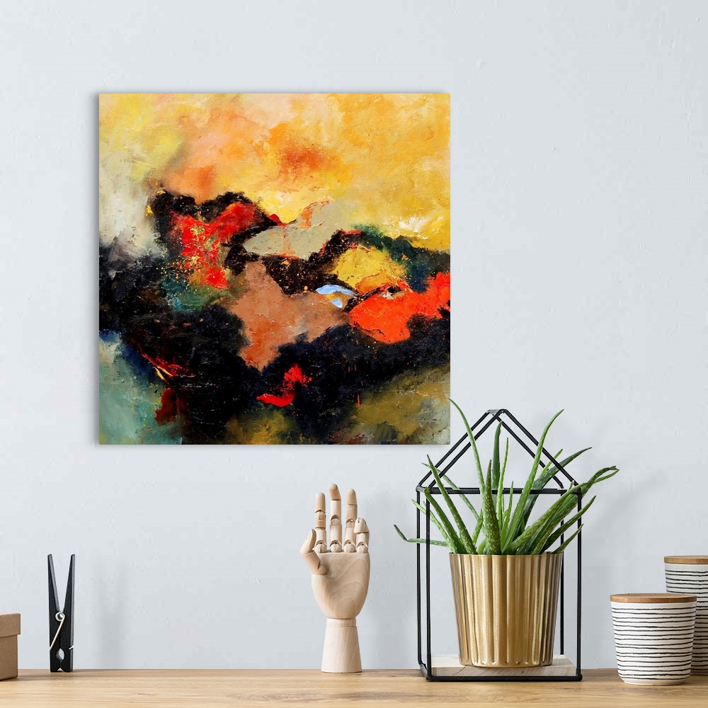 A bohemian room featuring A square abstract landscape with vivid colors of yellow and orange.