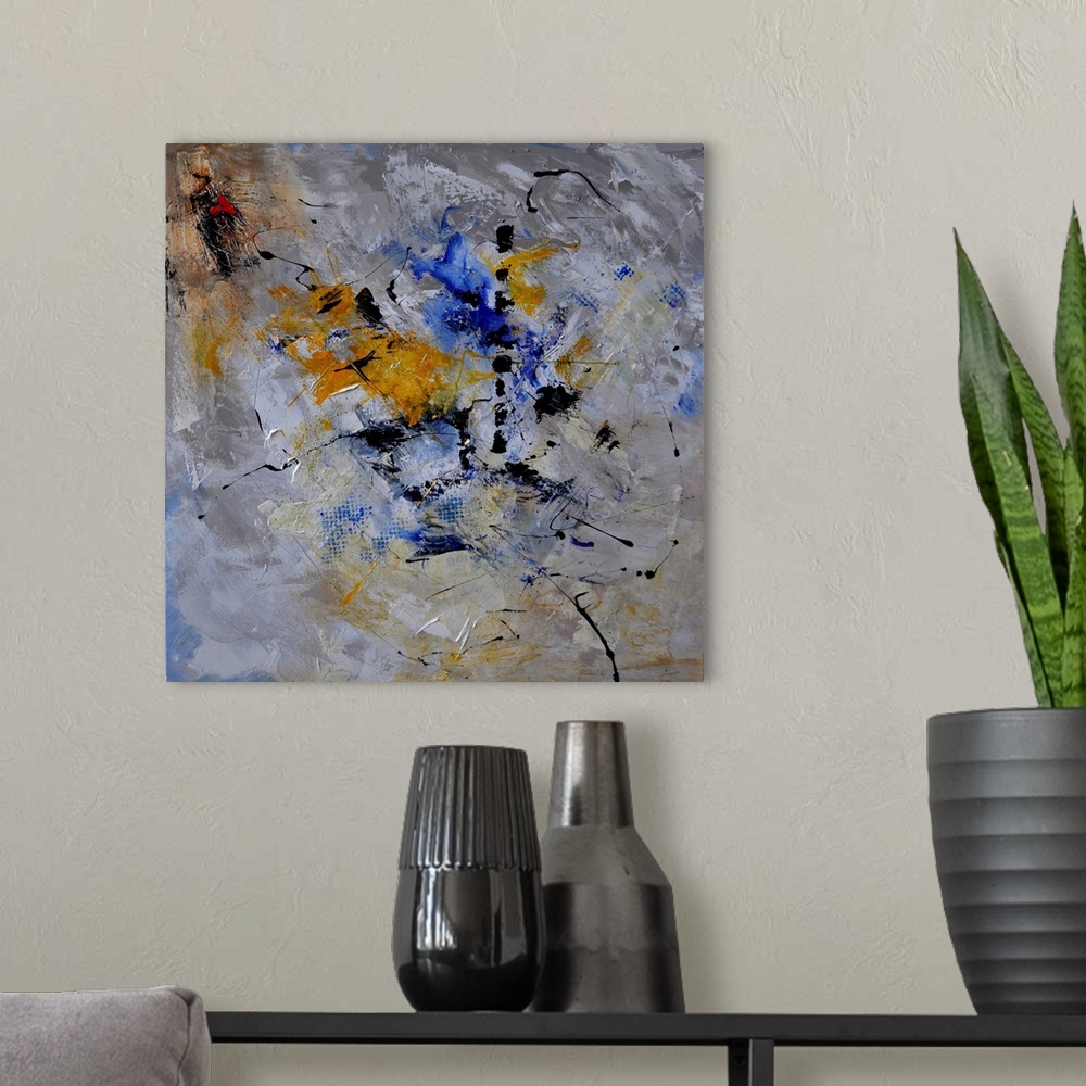 A modern room featuring A square abstract painting in dark shades of gray, blue, white and yellow with splatters of paint...