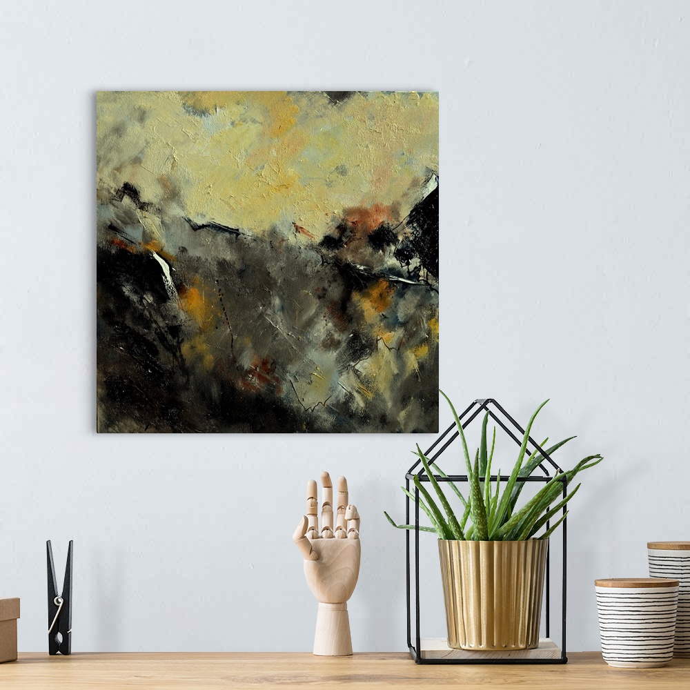 A bohemian room featuring A square abstract painting in dark shades of black, brown, white and yellow with splatters of pai...