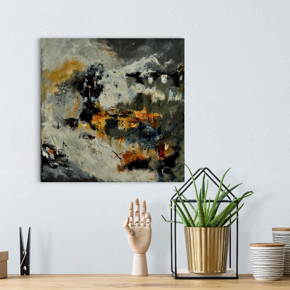 A bohemian room featuring A square abstract painting in dark shades of black, gray and yellow with splatters of paint overl...