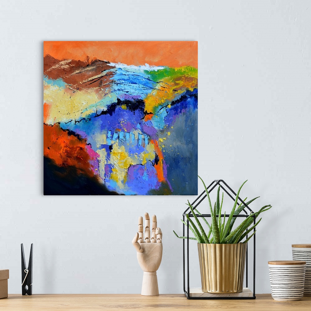A bohemian room featuring A square abstract painting in textured shades of orange, blue, red and yellow with splatters of p...