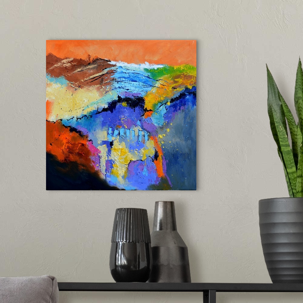 A modern room featuring A square abstract painting in textured shades of orange, blue, red and yellow with splatters of p...