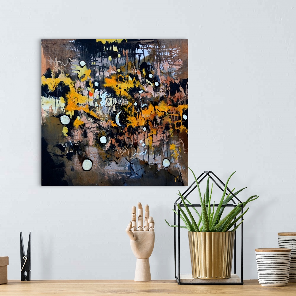 A bohemian room featuring A square abstract painting in dark shades of black, brown, white and orange with splatters of pai...