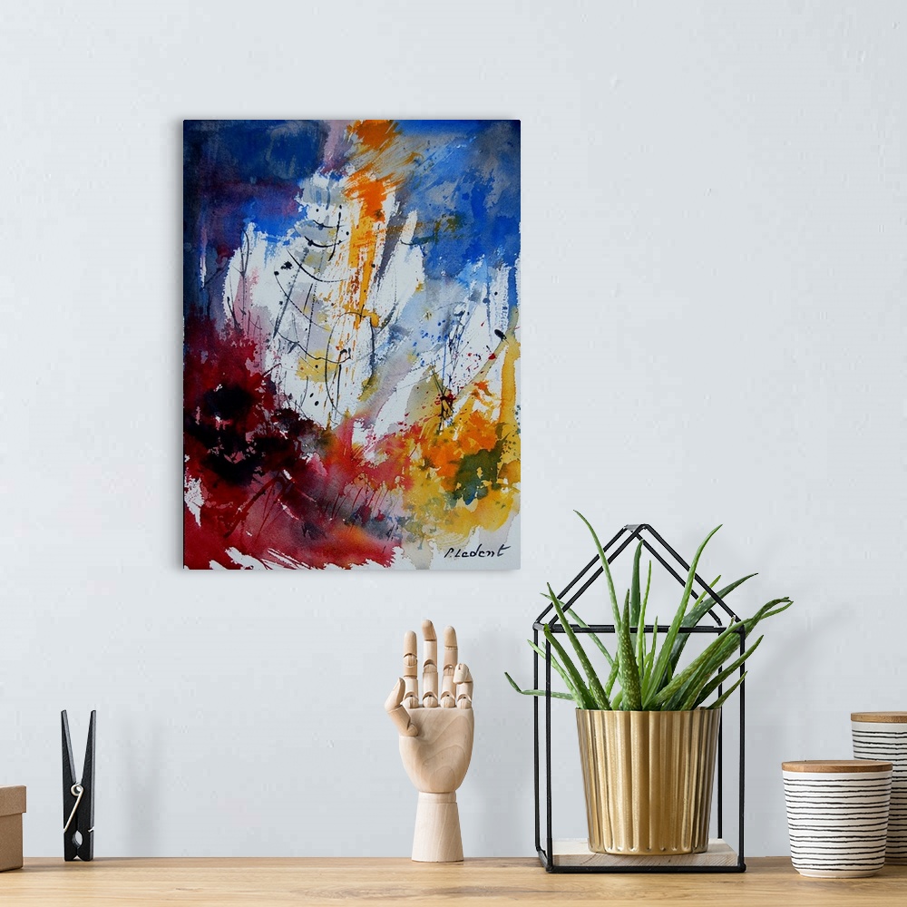 A bohemian room featuring A vertical abstract painting with deep colors of blue, red and yellow.