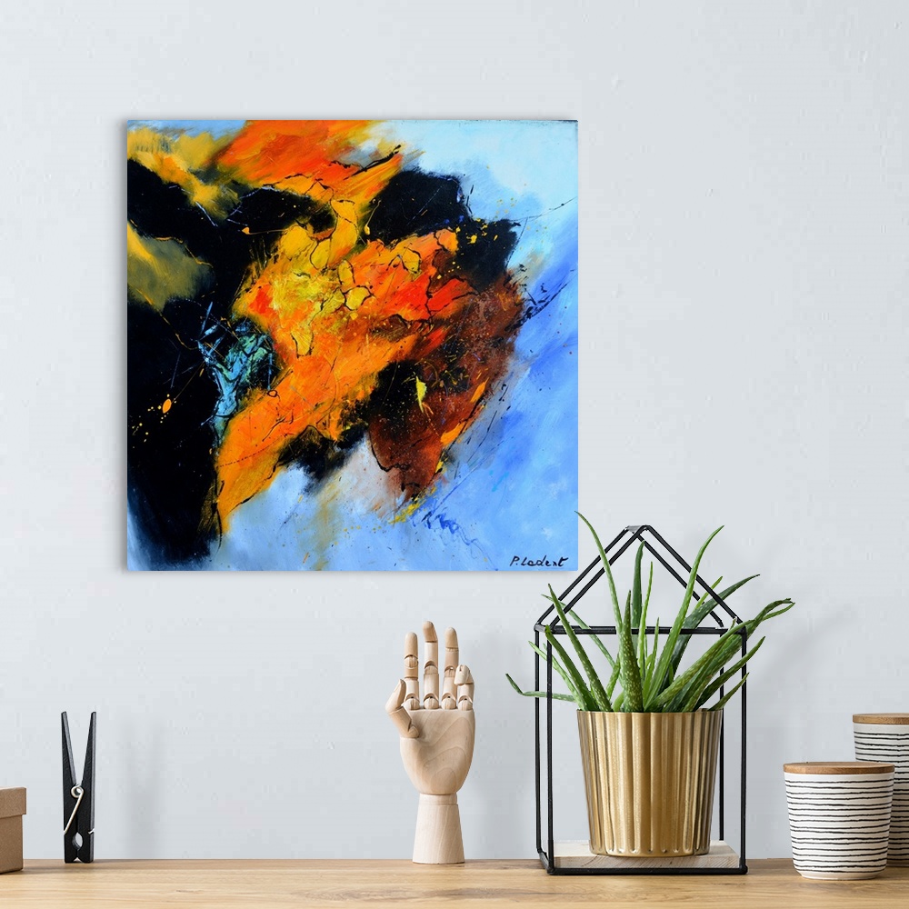 A bohemian room featuring Abstract painting representing a bull's head from the side in vibrant orange, red, and yellow hue...