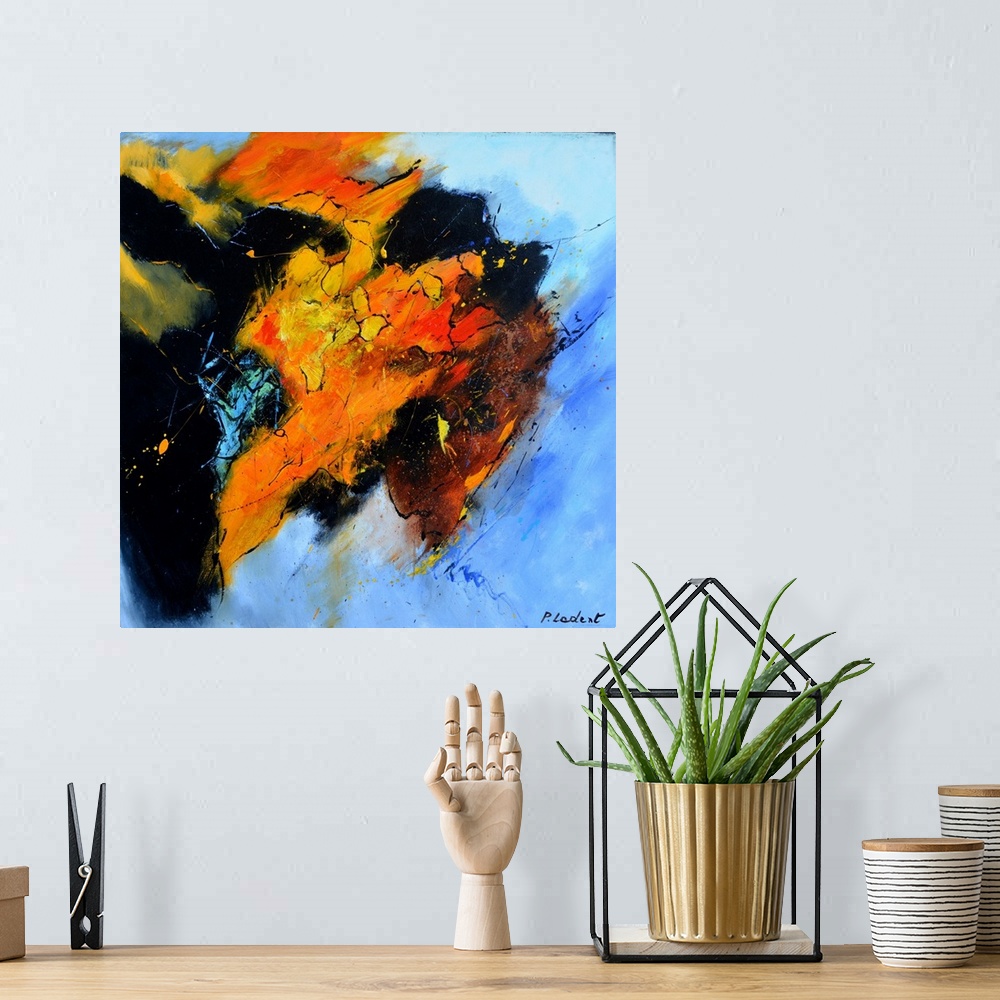 A bohemian room featuring Abstract painting representing a bull's head from the side in vibrant orange, red, and yellow hue...