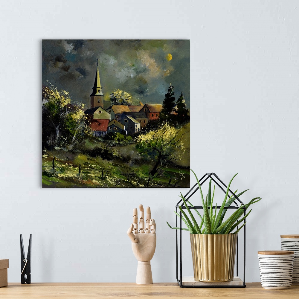 A bohemian room featuring Square painting of a darkened landscape with a field in the foreground and a Belgium village in t...