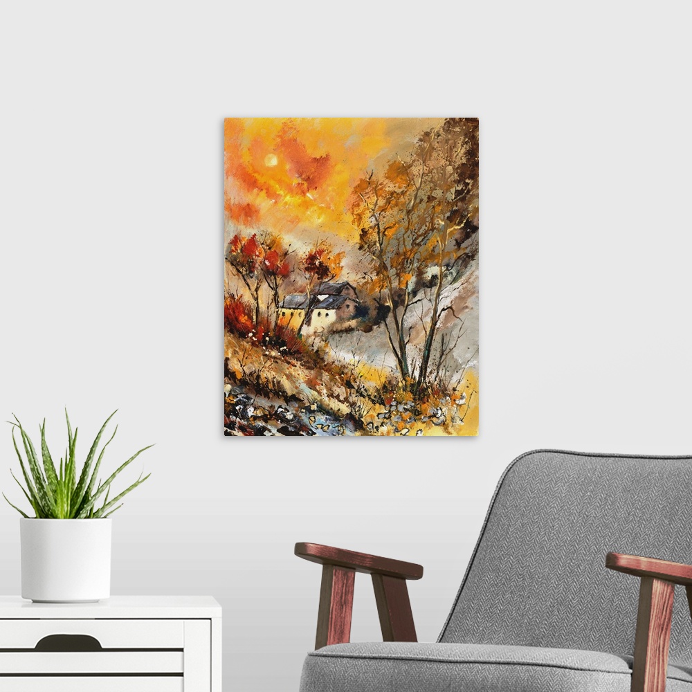 A modern room featuring Vertical painting of bare trees in a field of golden grass with a vibrant golden sky on an autumn...