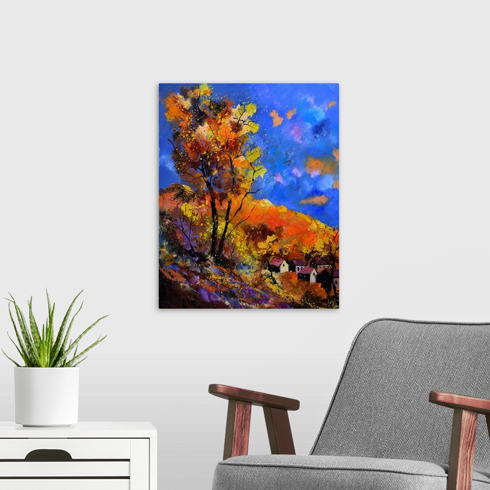 A modern room featuring Vibrant painting of an autumn day with blossoming trees, a colorful sky, and a village in the dis...