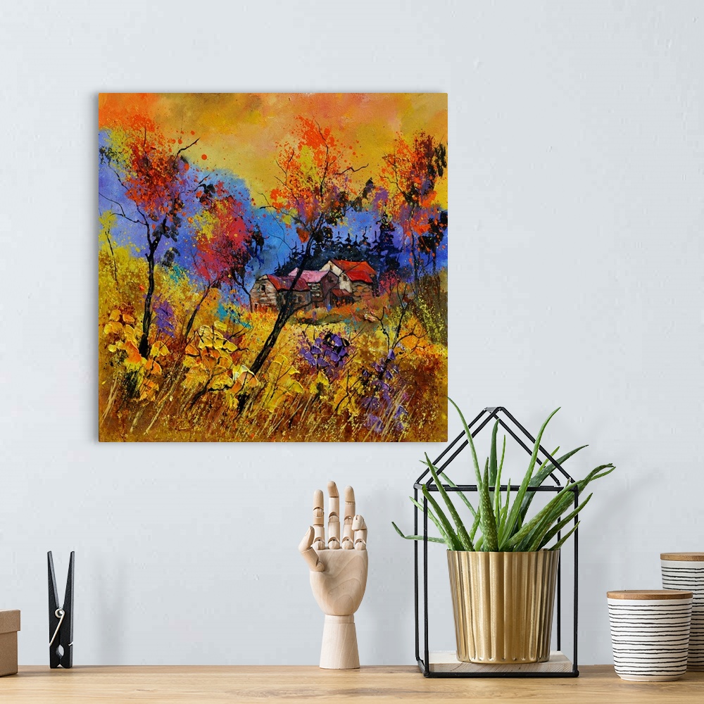 A bohemian room featuring Vibrant painting of a fall day with golden trees, a colorful sky, and a house in the distance.