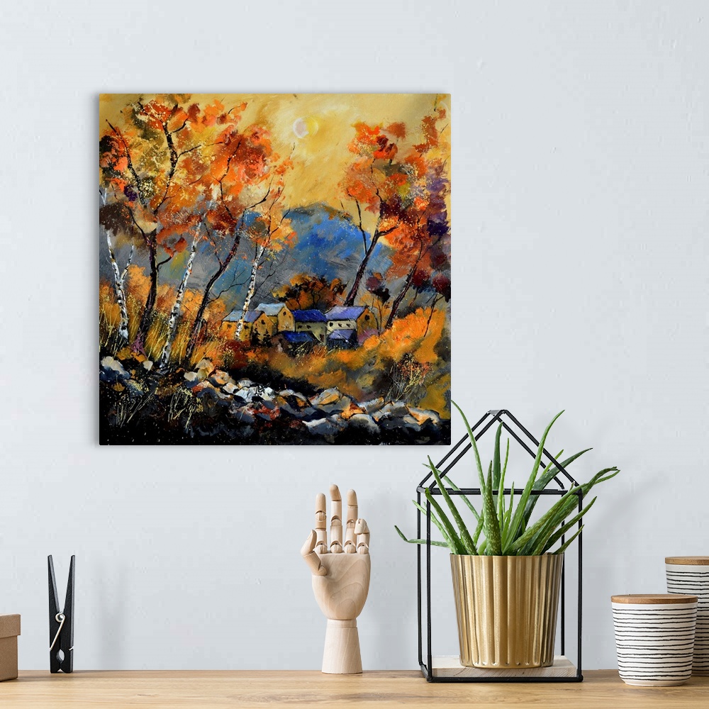 A bohemian room featuring Vibrant painting of a fall day with golden trees, a colorful sky, and a village in the distance.