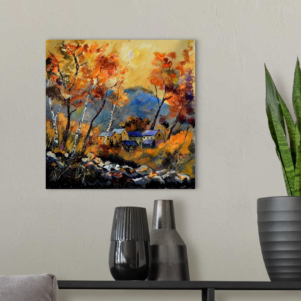 A modern room featuring Vibrant painting of a fall day with golden trees, a colorful sky, and a village in the distance.