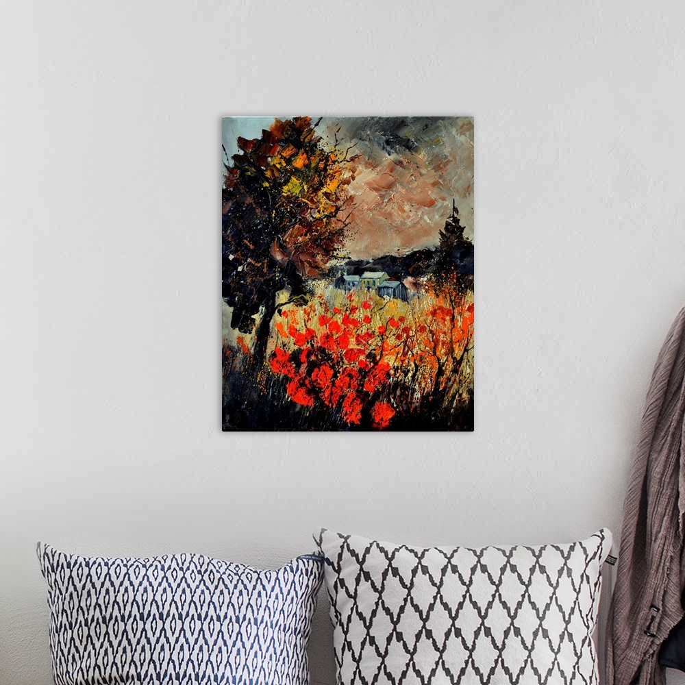 A bohemian room featuring An autumn scene of red blooming flowers in a field near a small village.