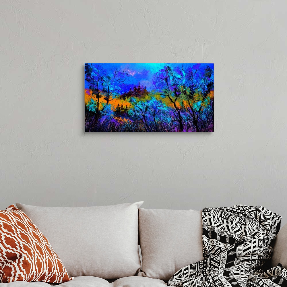 A bohemian room featuring Horizontal painting landscape of blue trees in the foreground and a bright warm sky in the backgr...
