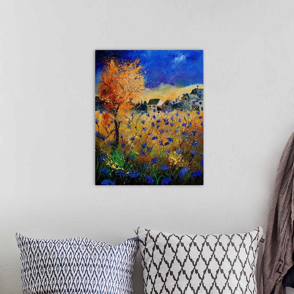 A bohemian room featuring A vertical abstract landscape of a field of blue flowers in front of a village.
