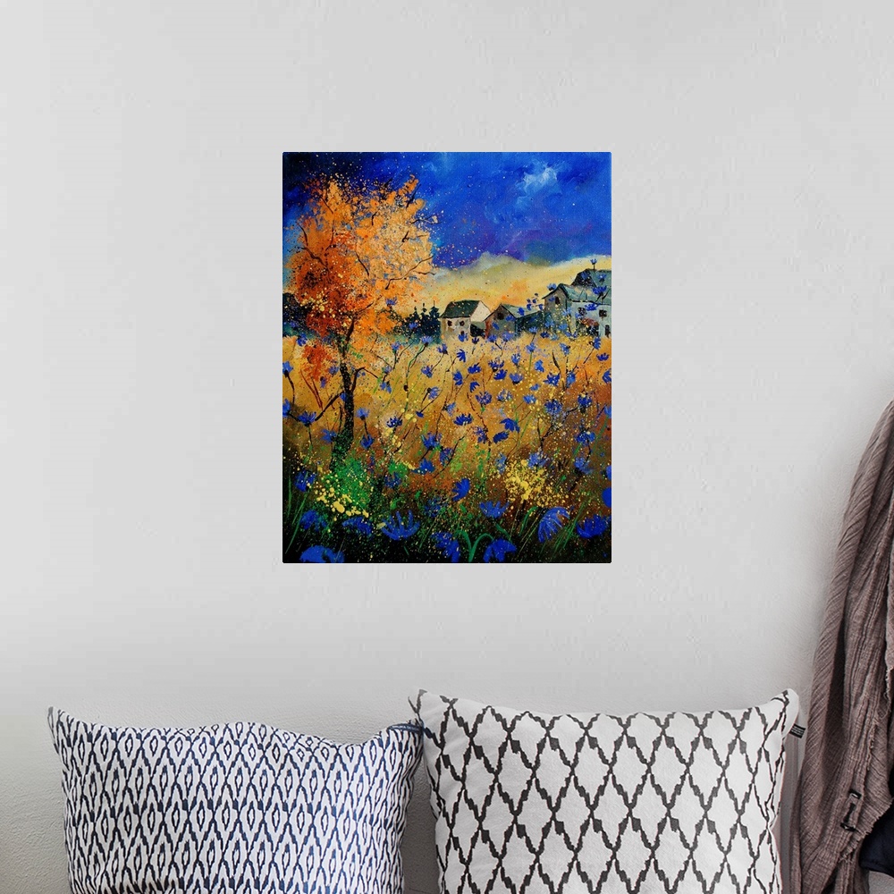 A bohemian room featuring A vertical abstract landscape of a field of blue flowers in front of a village.