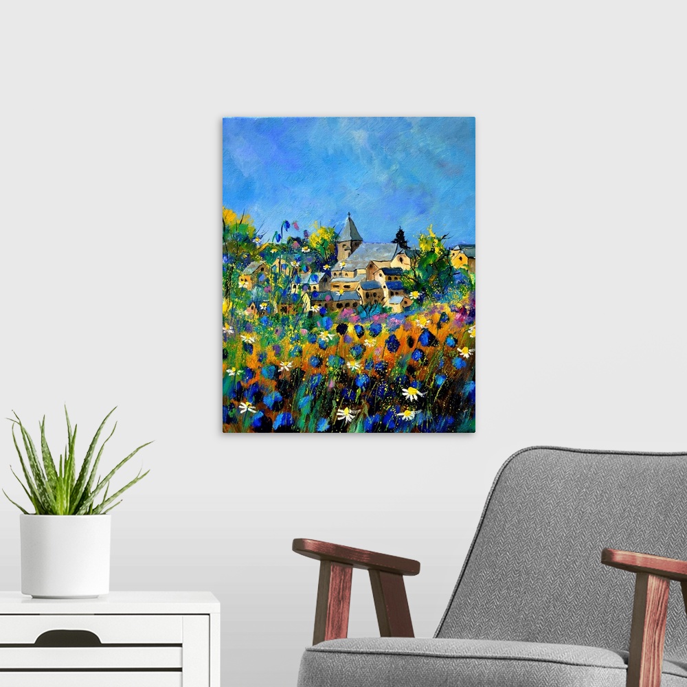 A modern room featuring Vertical painting of a field of colorful flowers in the foreground and a Belgium village in the b...