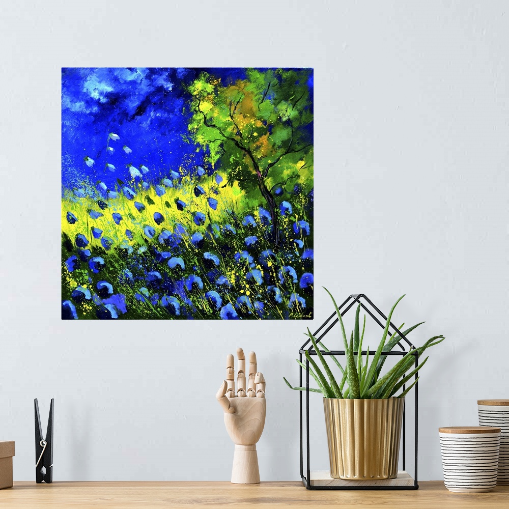 A bohemian room featuring Square painting of blue poppies in a field and a bright blue sky with small speckles of paint ove...
