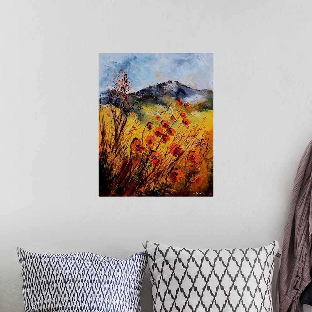 A bohemian room featuring A vertical country landscape of orange wildflowers in a field with mountains in the background.