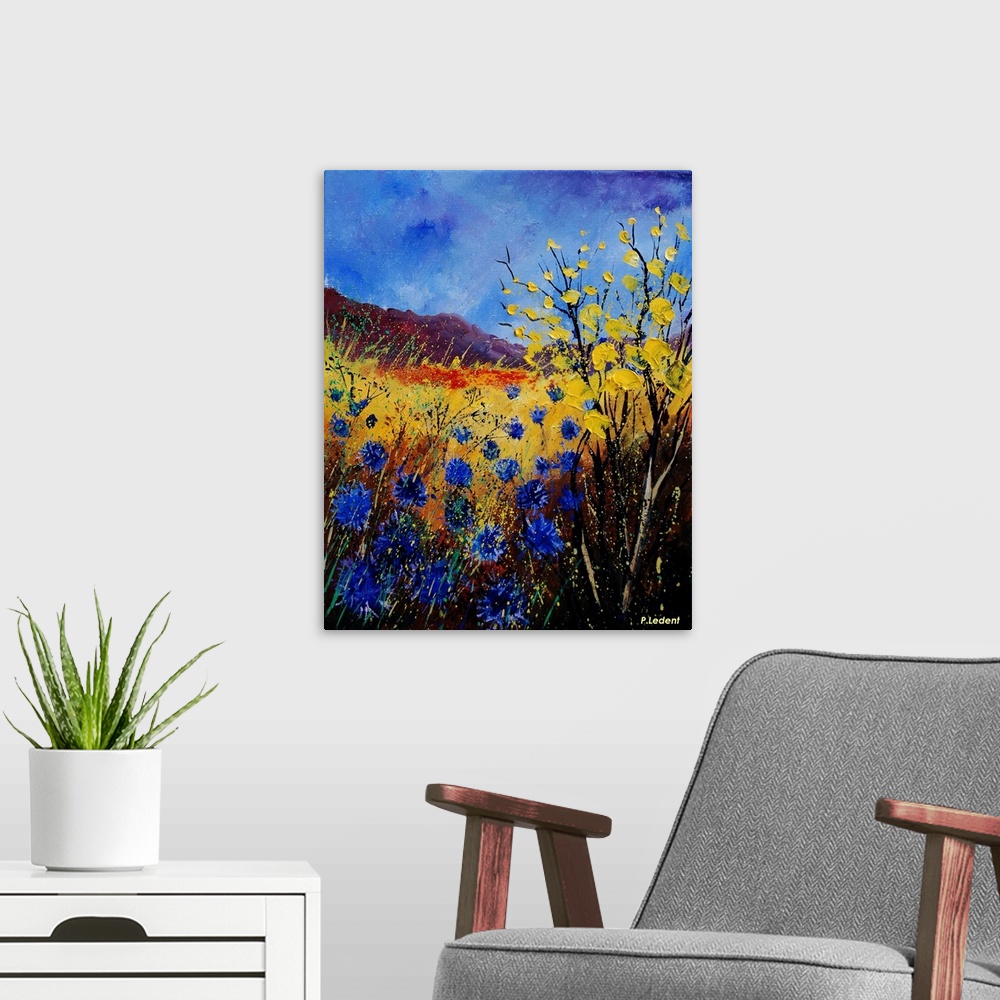 A modern room featuring Contemporary painting of a field of cornflowers in blue, yellow and orange.