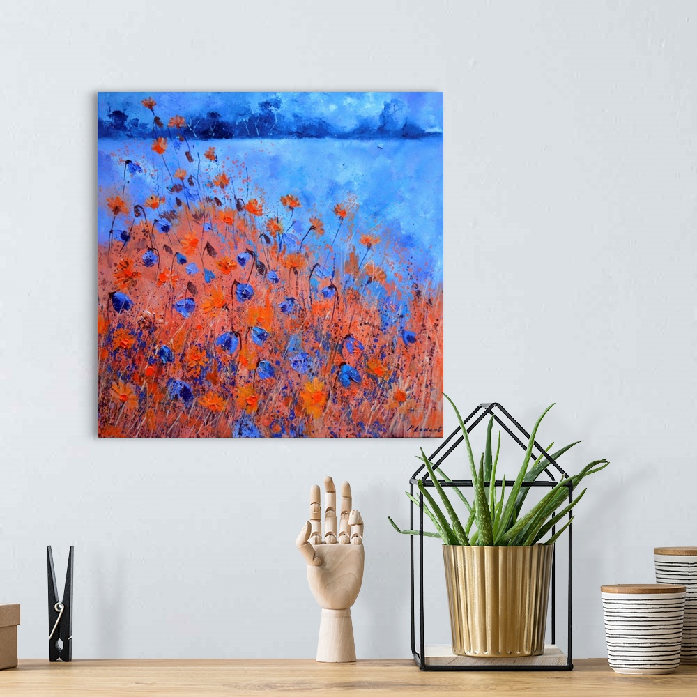 A bohemian room featuring Contemporary landscape painting of a field of blue and red cornflowers.