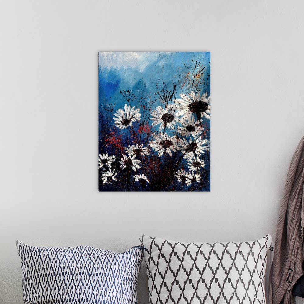 A bohemian room featuring Vertical painting of a group of white daises in front of a blue backdrop.