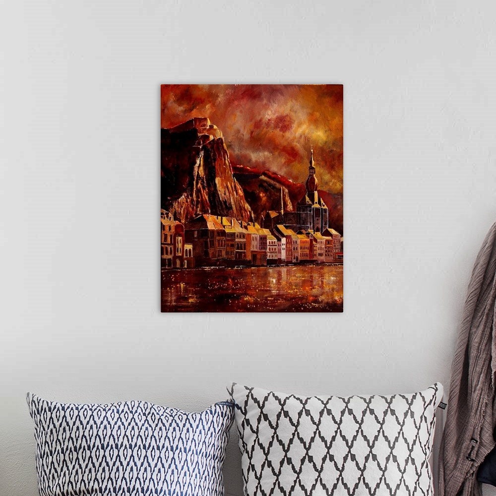 A bohemian room featuring A solemn painting of the city of Dinant in Belgium in warm colors of red.