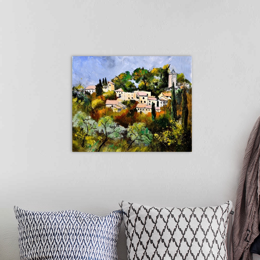 A bohemian room featuring Painting of a tree filled landscape in the foreground and a French village in the background with...