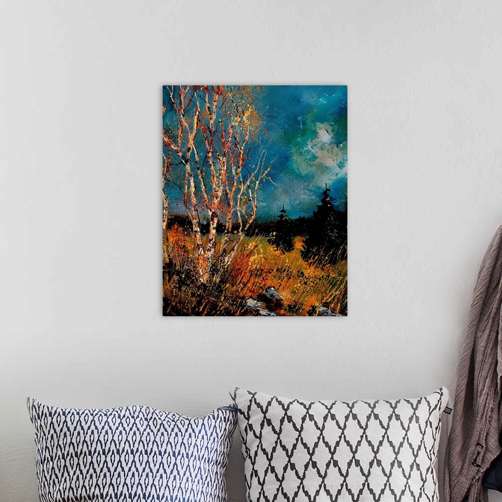 A bohemian room featuring Vertical painting of bare trees in a field of golden grass with a dark stormy sky.