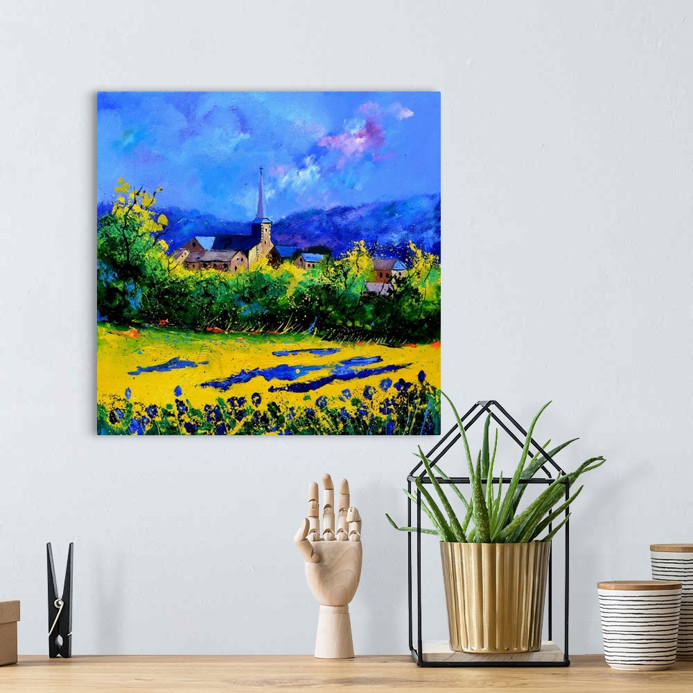 A bohemian room featuring Vibrant painting of a bright day with blossoming trees, a colorful sky, and a village in the dist...