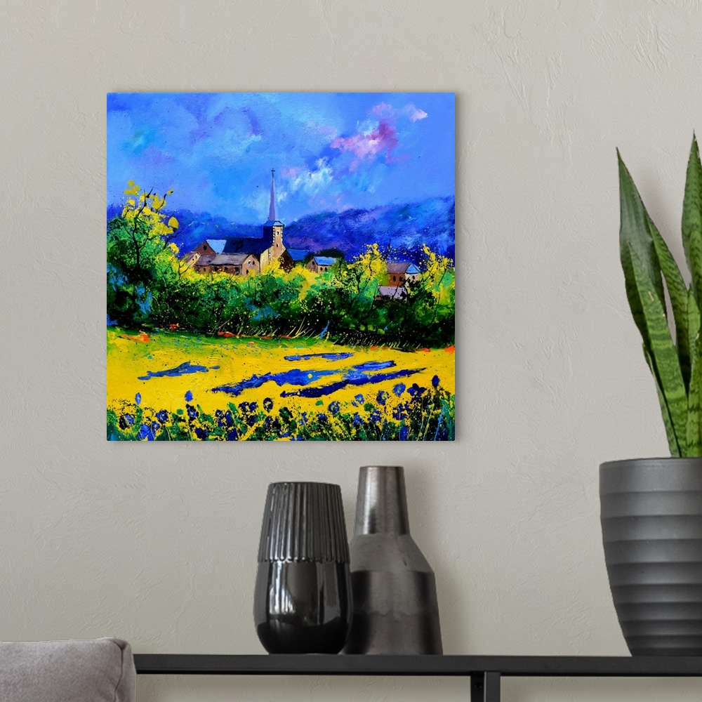 A modern room featuring Vibrant painting of a bright day with blossoming trees, a colorful sky, and a village in the dist...