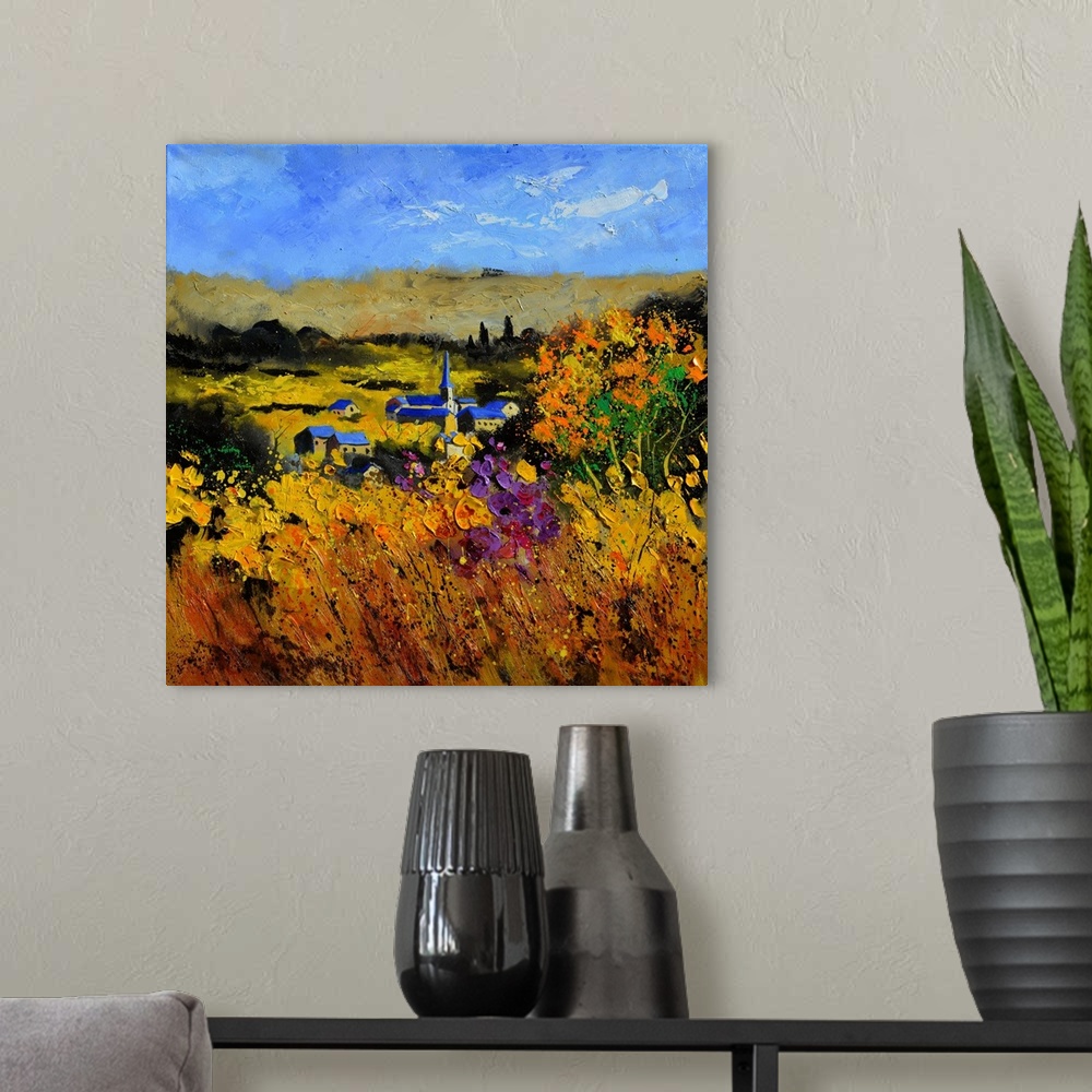 A modern room featuring Square painting of a field with flowers in the foreground and a Belgium village in the background...