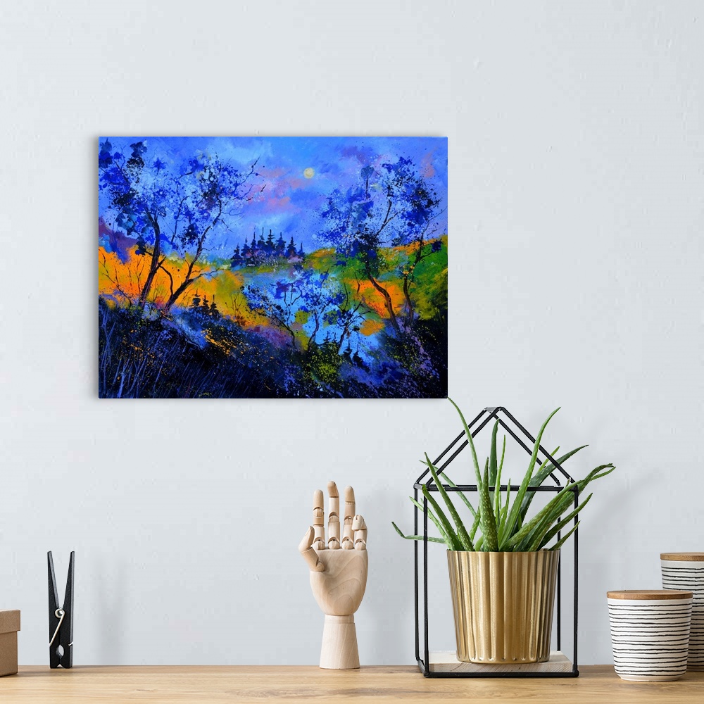 A bohemian room featuring Vibrant painting in blue tones of  trees, a colorful sky, and rolling hills in the distance.