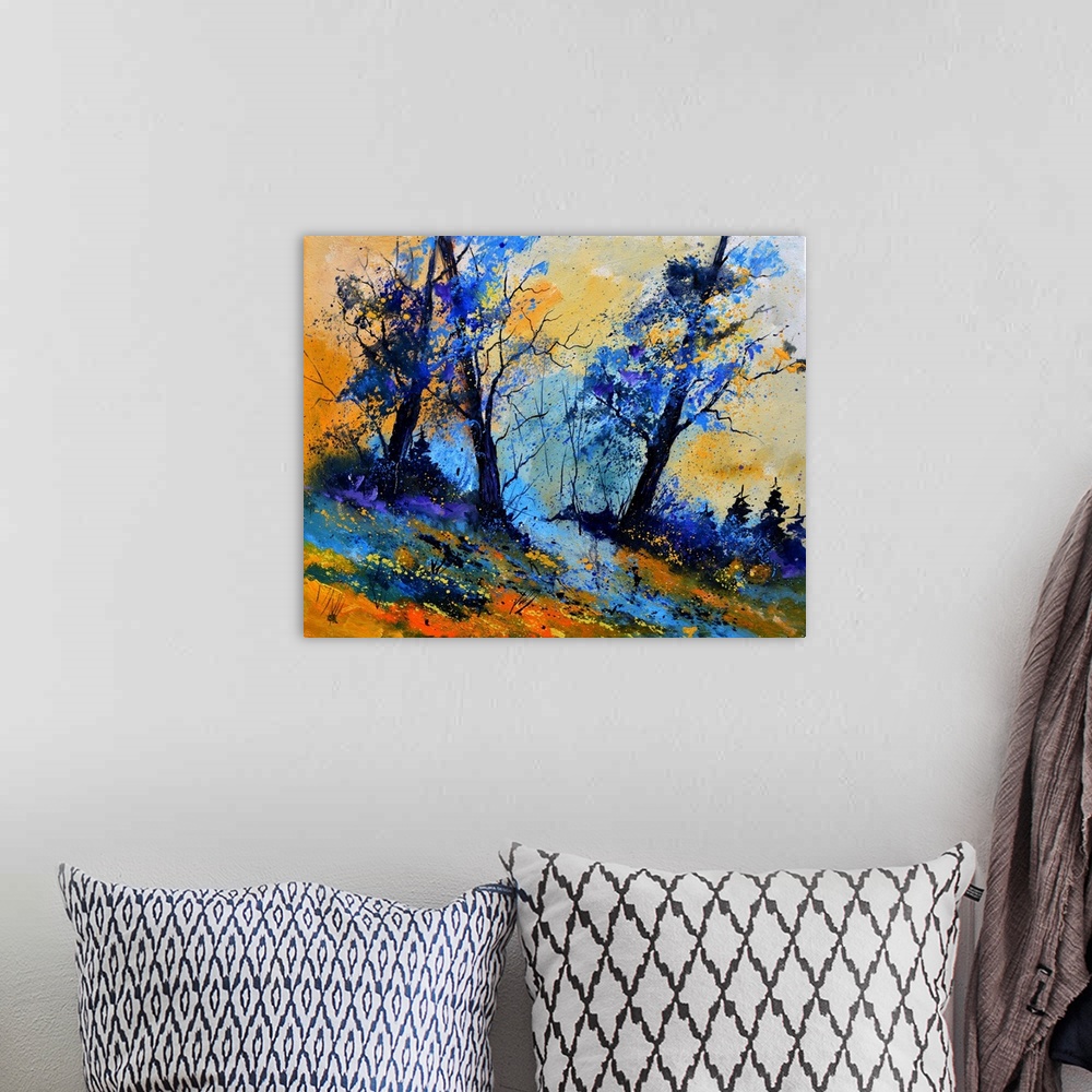 A bohemian room featuring Vibrant painting of blue leaved trees, a colorful sky, and orange grass in the foreground.