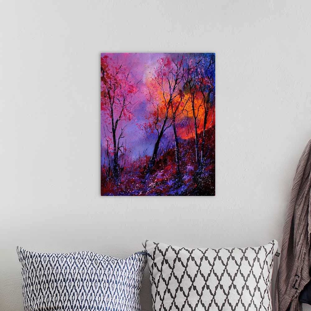 A bohemian room featuring A vibrant colored painting of a forest with a bed of flowers and a pink and orange sky.