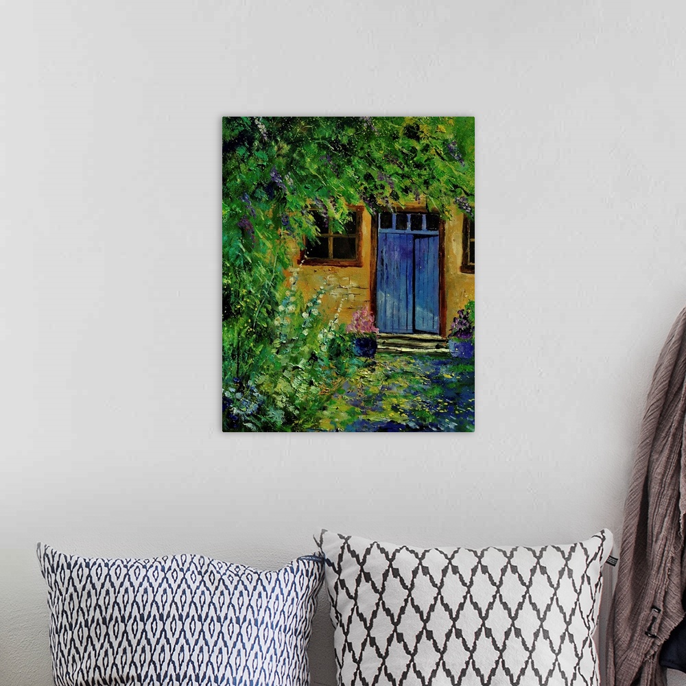 A bohemian room featuring Painting of a blue door to a building surrounded by a overgrown garden.