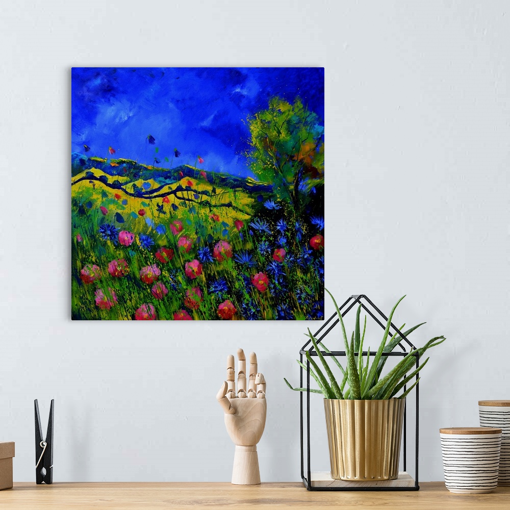 A bohemian room featuring Vibrant painting of a bright Summer day with blooming flowers, a colorful sky, and rolling hills ...