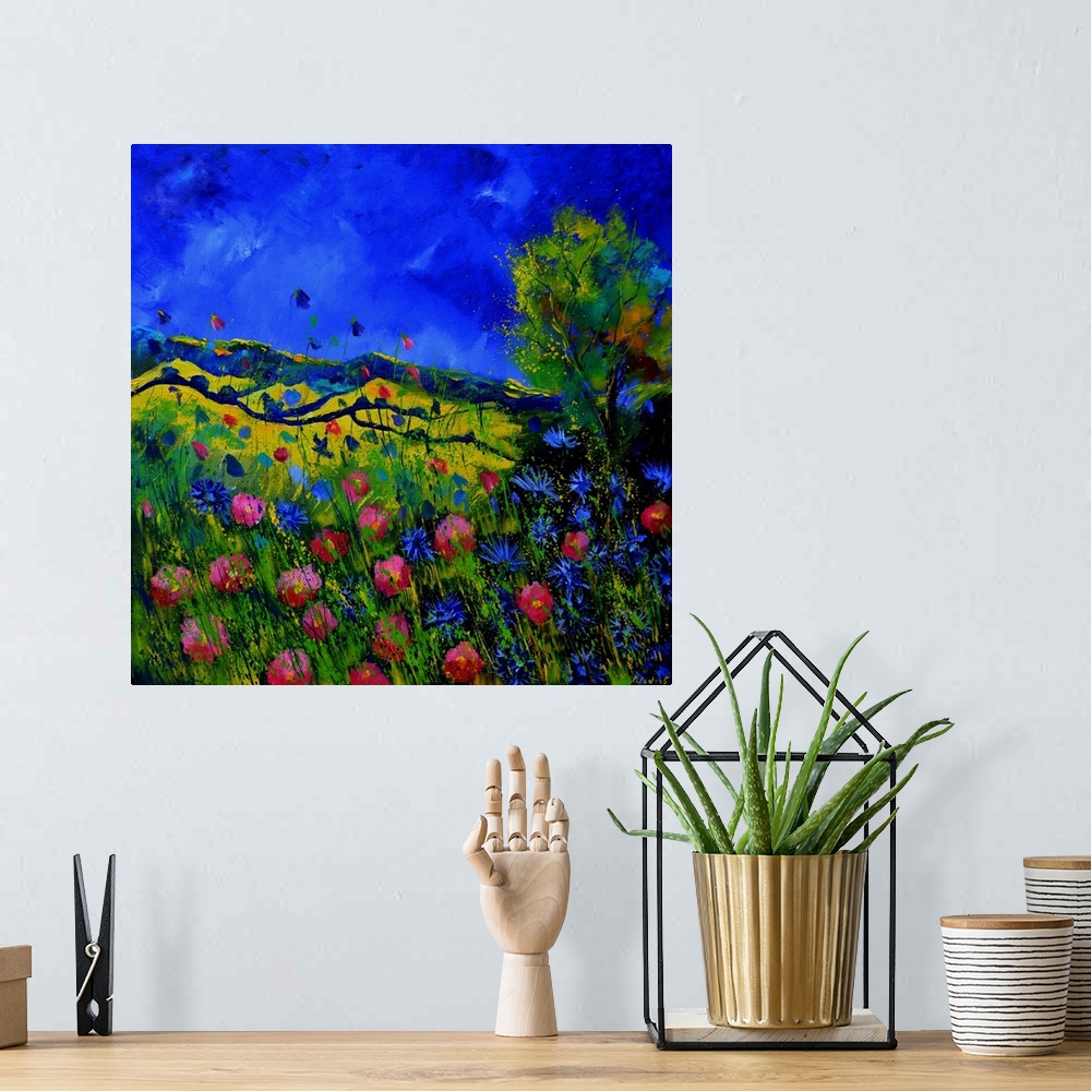 A bohemian room featuring Vibrant painting of a bright Summer day with blooming flowers, a colorful sky, and rolling hills ...