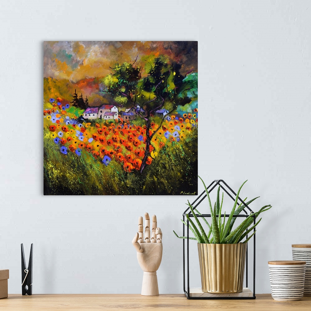 A bohemian room featuring Contemporary painting with a field of poppy flowers in the foreground and a village in the backgr...