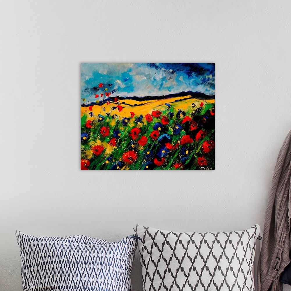 A bohemian room featuring Horizontal painting of a colorful landscape with red and blue poppies in the foreground and rolli...