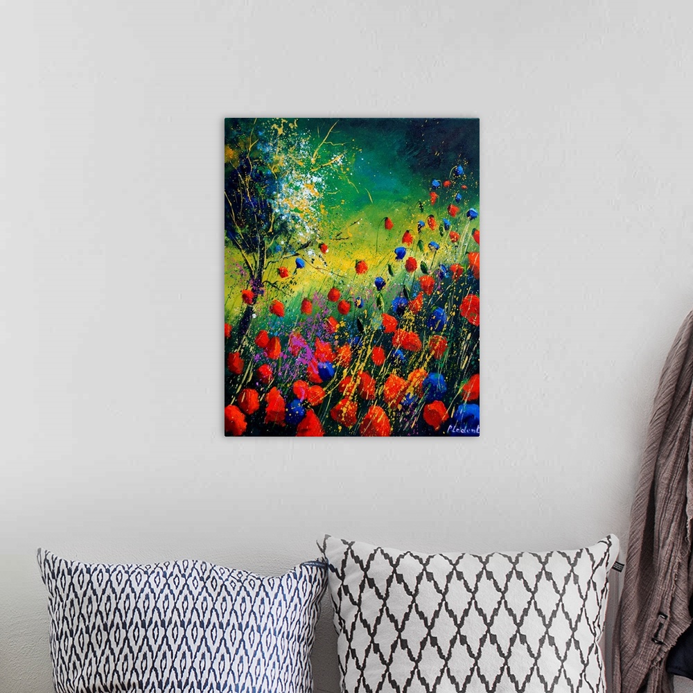 A bohemian room featuring Vertical painting of a field of red and blue poppies along with a single tree with splatters of m...