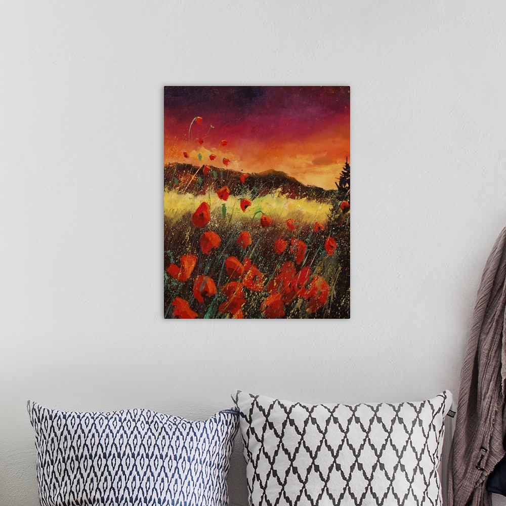 A bohemian room featuring Vertical painting of an vibrant landscape with red poppies in the foreground and a bright warm sk...