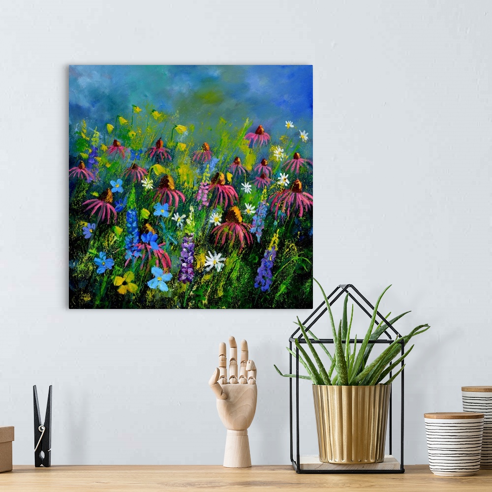 A bohemian room featuring Square painting of colorful flowers in a garden and a bright blue sky with small speckles of pain...